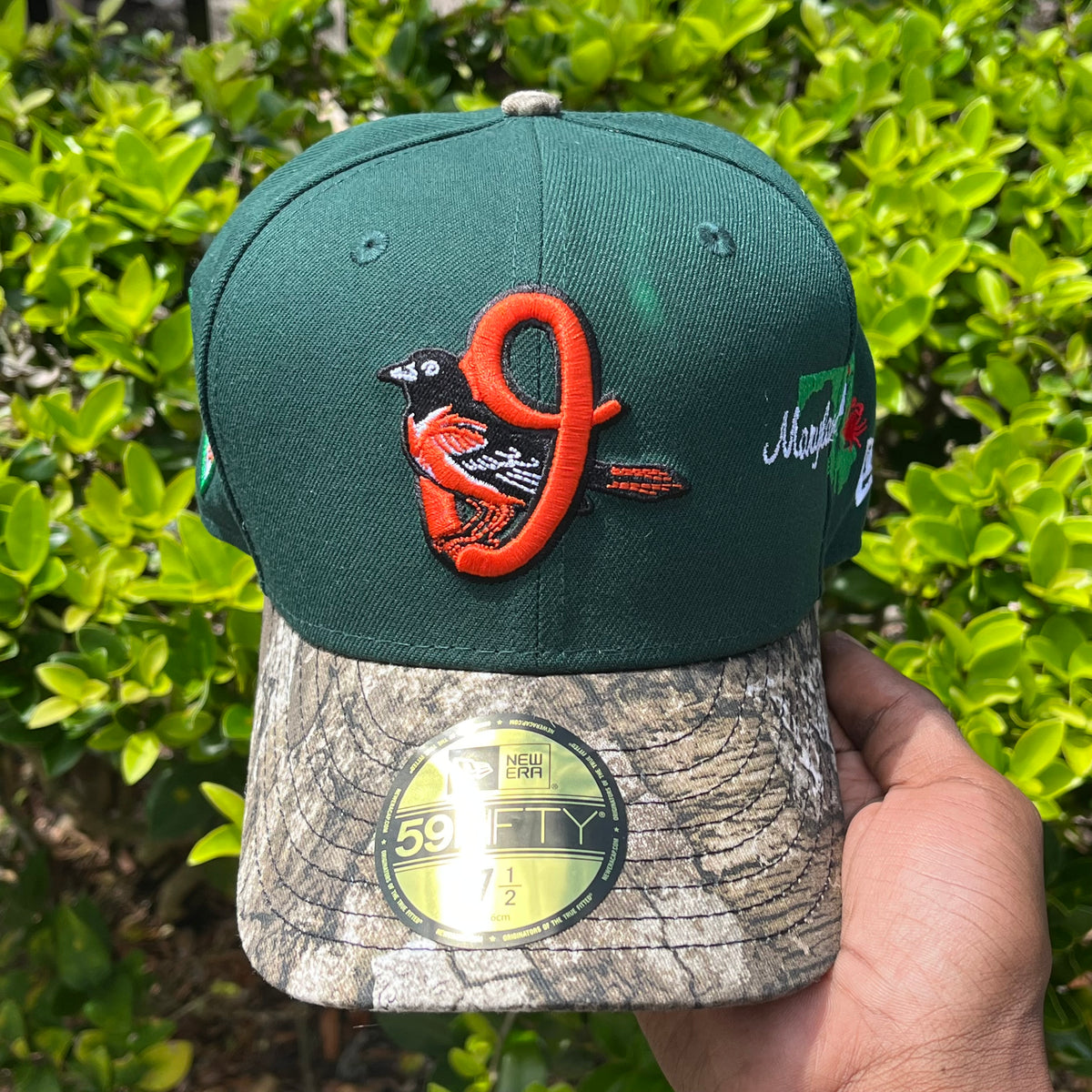 FOREST GREEN TWO-TONE CAMO BRIM (GREY UV) BALTIMORE ORIOLES 2026 CITY SIDE PATCH FITTED HAT